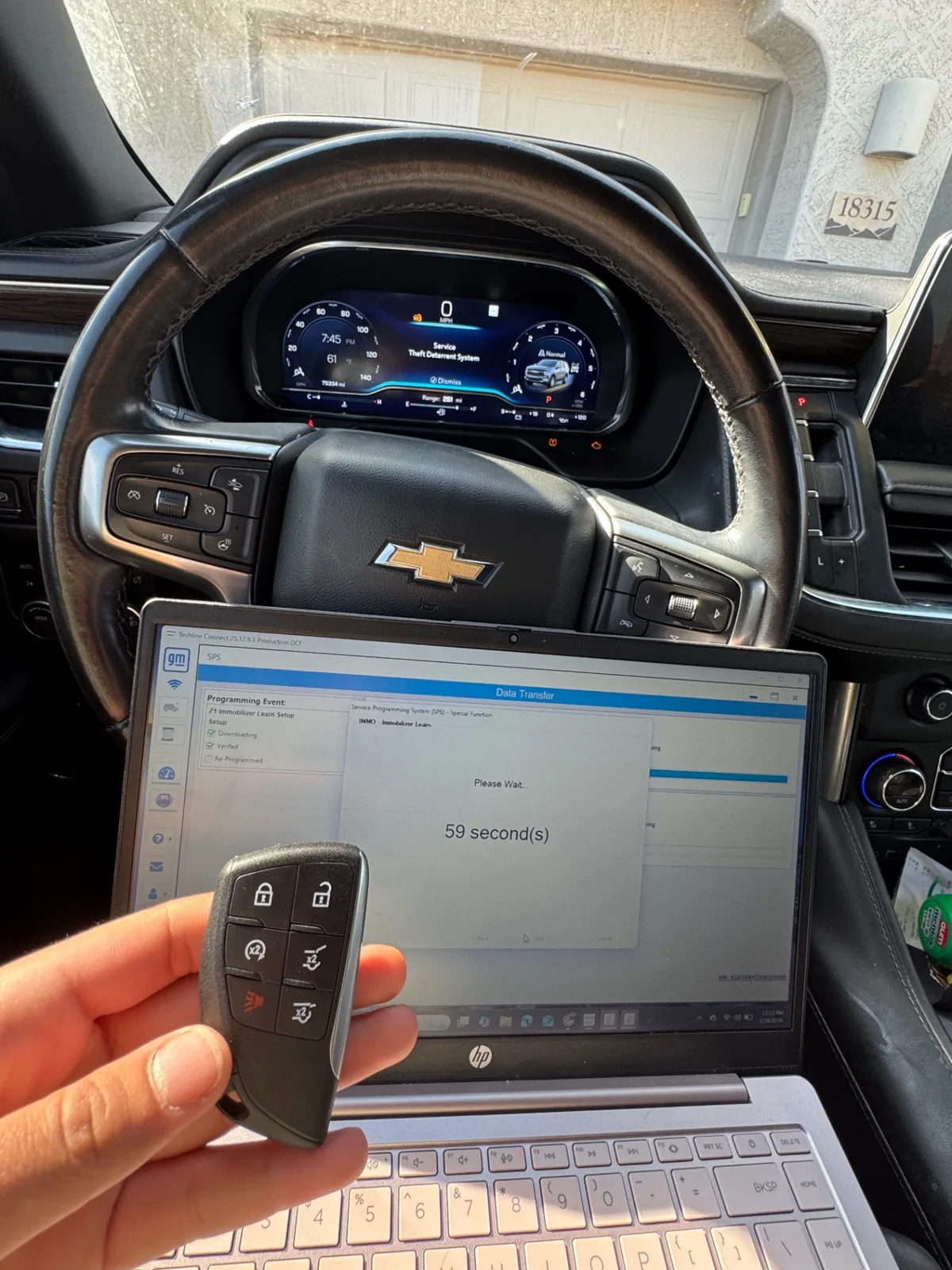 Autel key programmer connected to a Chevrolet Tahoe during on-site smart key programming